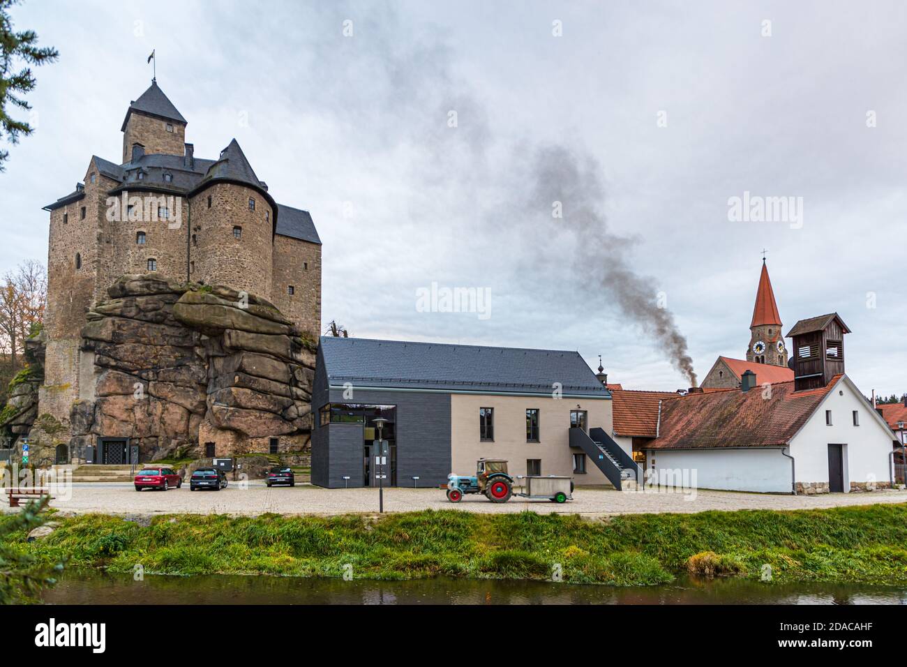 Black smoke rises above the Traditional Community Zoigl Brewery in Falkenberg, Germany Stock Photo