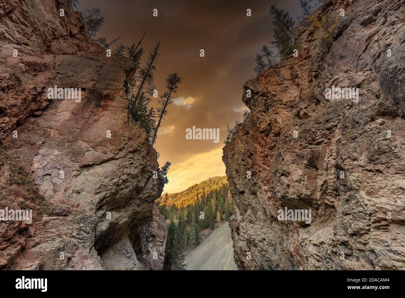 Altai mountains. The so called Red Gates. Beautiful highland landscape. Red mountains in the foreground. Dark orange sunset sky as a background. Russi Stock Photo