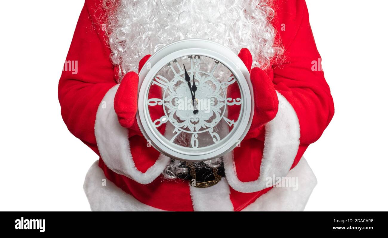 Santa Claus holding a white clock with both hands. The clock shows five ...