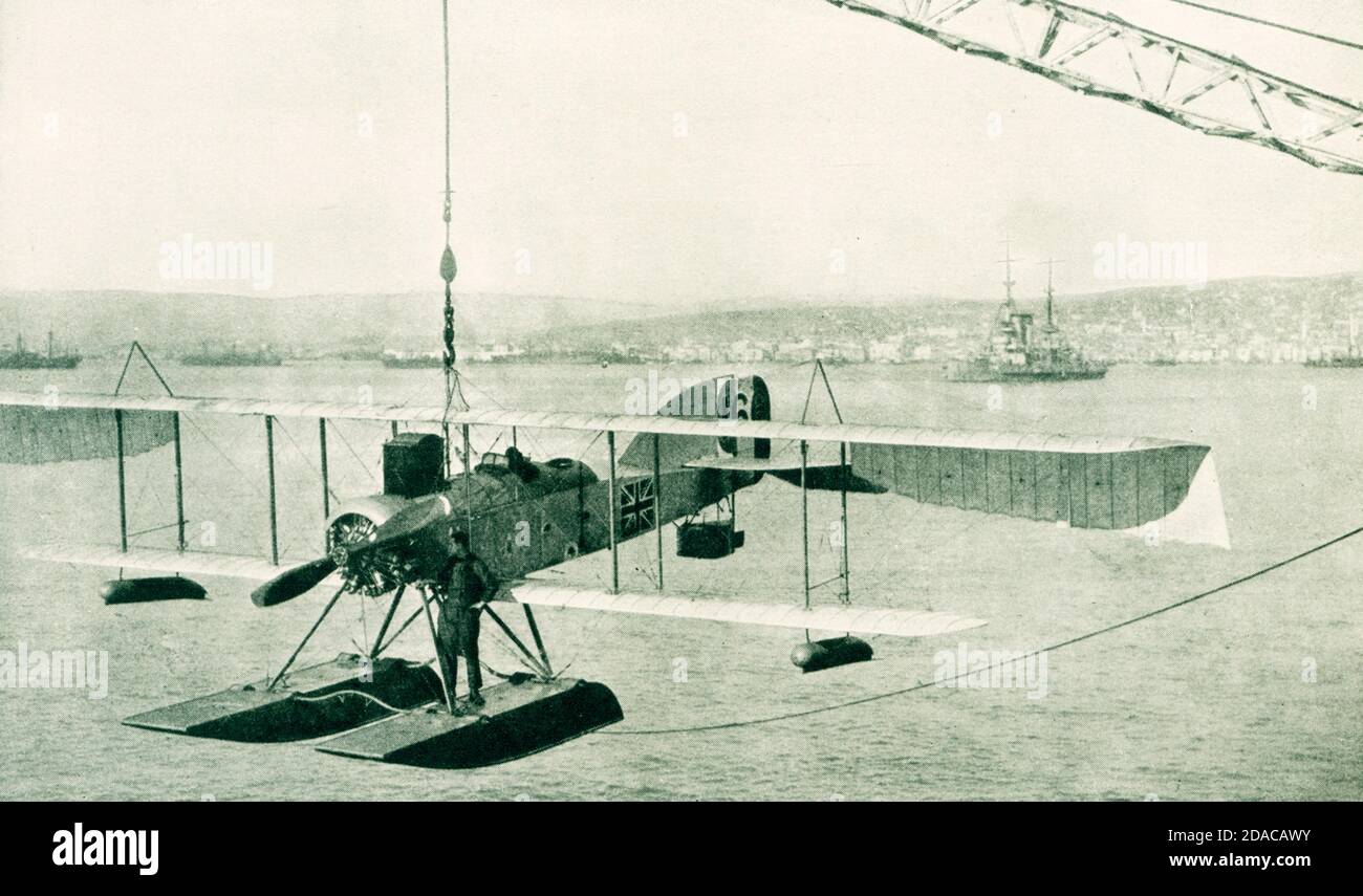 British hydroplane returning to mother ship after patrol duty over Saloniki. In the background are the city of Saloniki and warships of the allies. The time period is World War I, but no later than 1916. Stock Photo