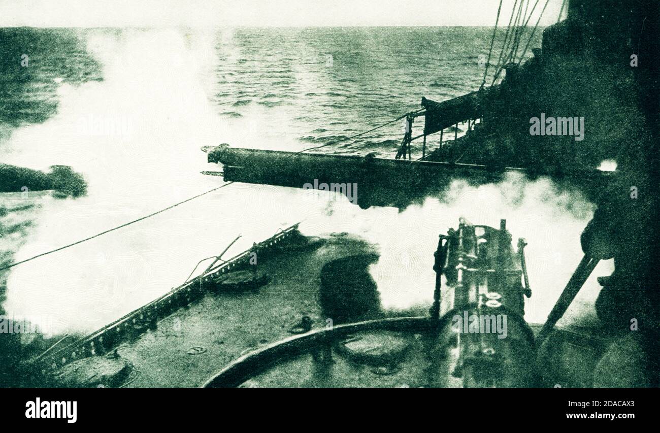 Torpedo being Fired. Firing a torpedo from deck of a german destroyer. The torpedo has just left the tube. Dropping into the water it will continue its course, like a small submarine, straight to its mark. The time period is World War I, but the photo dates to 1916 at the latest. Stock Photo