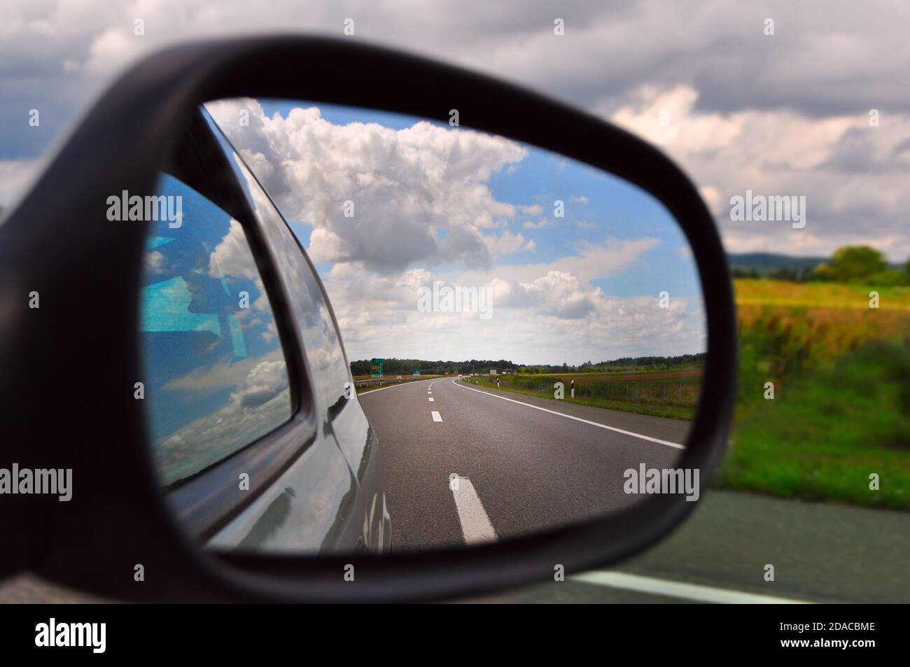 Rearview mirror view from the car, road trip, travel Stock Photo