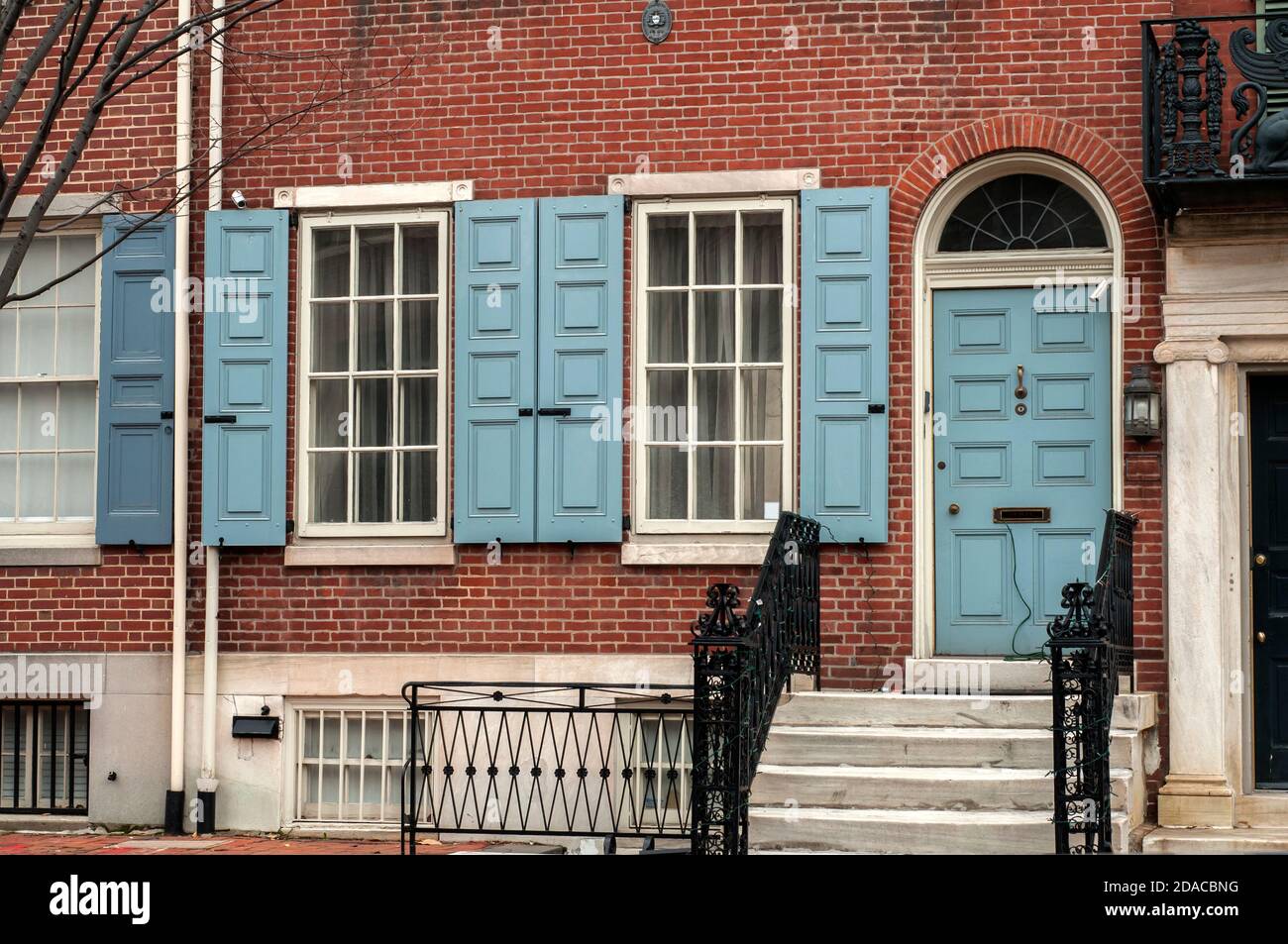 Facade of vintage brick house with door and wooden windows Stock Photo ...