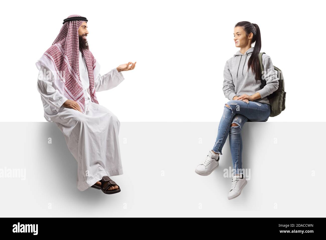 Saudi arab man and a female student sitting on a panel and talking isolated on white background Stock Photo