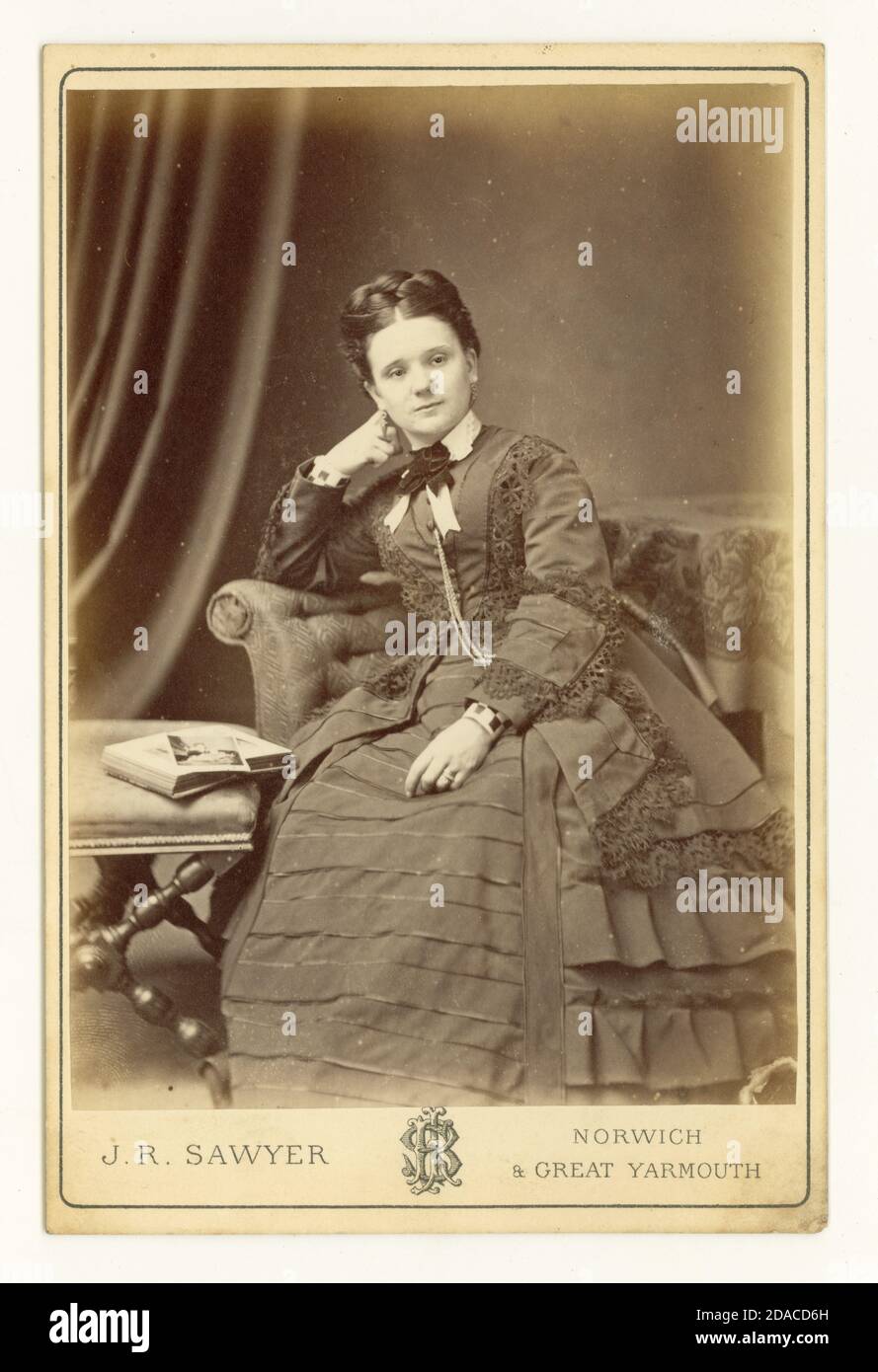 Original Victorian cabinet card studio portrait of pretty woman, studio of  J.R. Sawyer, Norwich or Great Yarmouth, Norfolk, dated Sept 1873. Stock Photo