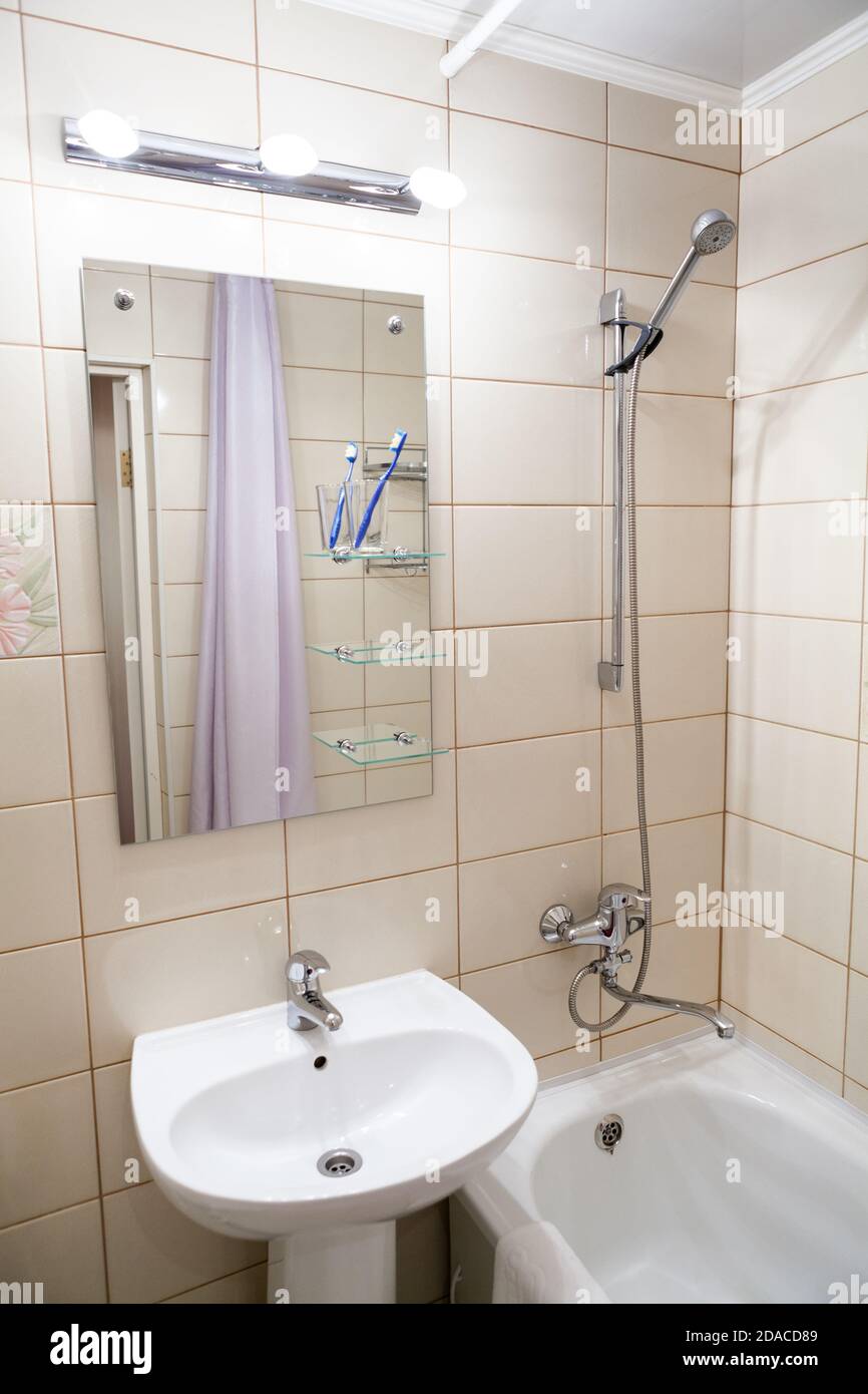 Interior Of Simple Half Bathroom With Sink With Mirror And Bath With Shower A White Sanitary Ware Stock Photo Alamy Interior Of Simple Half Bathroom With Sink With Mirror And Bath With Shower A White Sanitary Ware Stock Photo Alamy