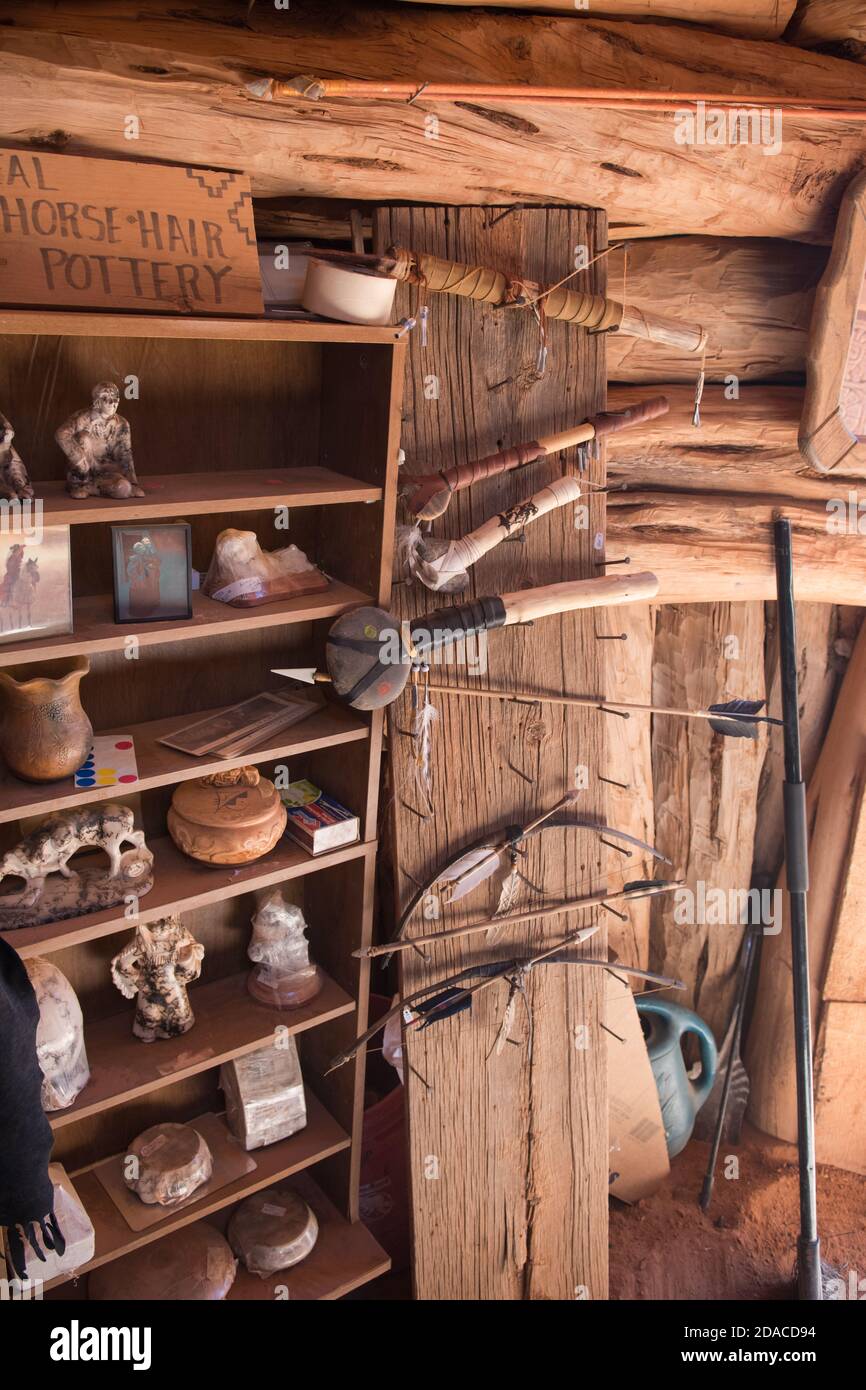 A display of horse hair pottery, bows ans arrows and clubs for sale in a Navajo hogan, Utah, USA Stock Photo