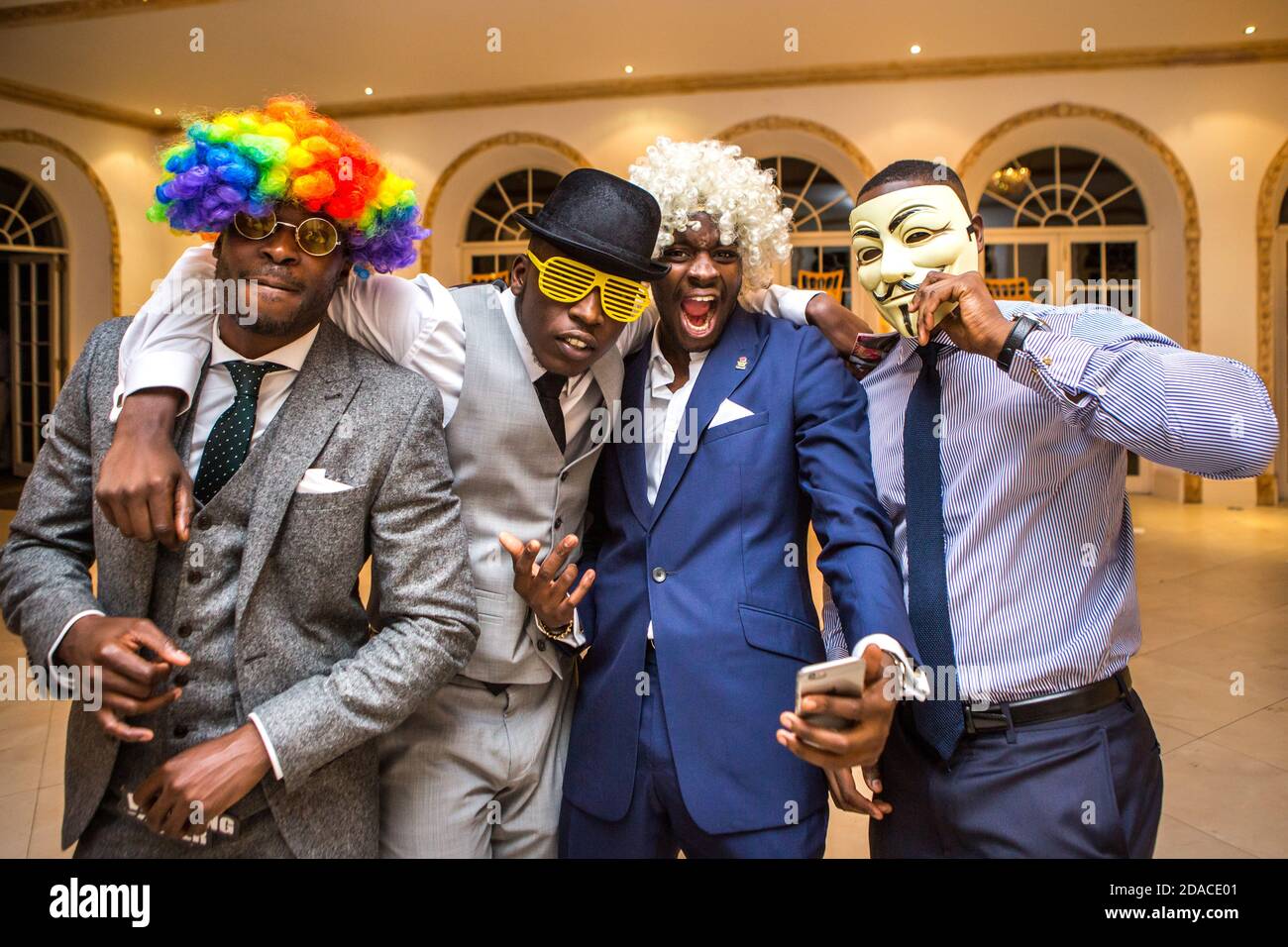 masked men at a party Stock Photo