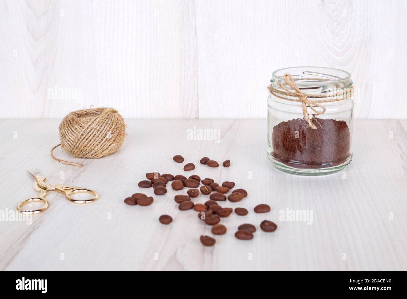Ground coffee in a small glass jar decorated with jute thread. Concept of hand made natural air freshener. Stock Photo