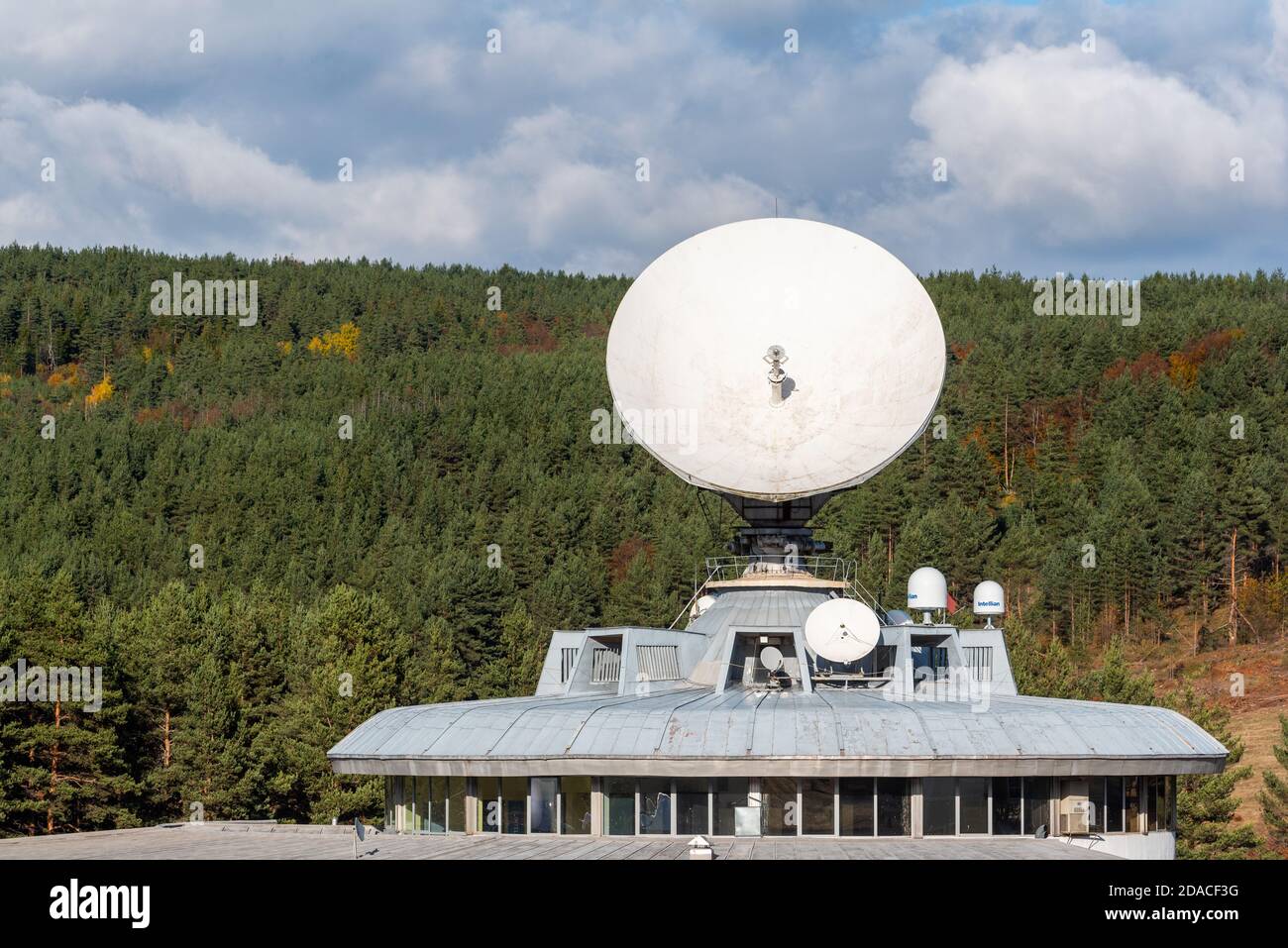 Business electrical dish media satellite space radio high power antenna  against cloudy blue sky forest station hidden Stock Photo - Alamy