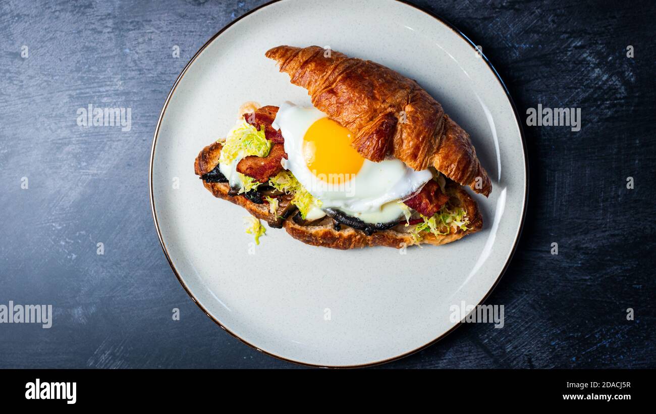 Portobello Croissant Breakfast Sandwich with sunny up egg Stock Photo