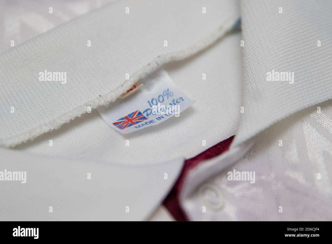 100% Polyester Made in UK label in a white sports shirt Stock Photo