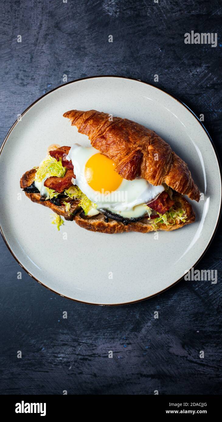 Portobello Croissant Breakfast Sandwich with sunny up egg Stock Photo