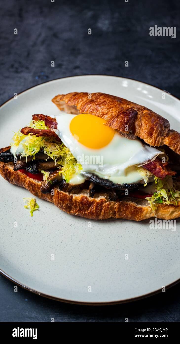 Portobello Croissant Breakfast Sandwich with sunny up egg Stock Photo
