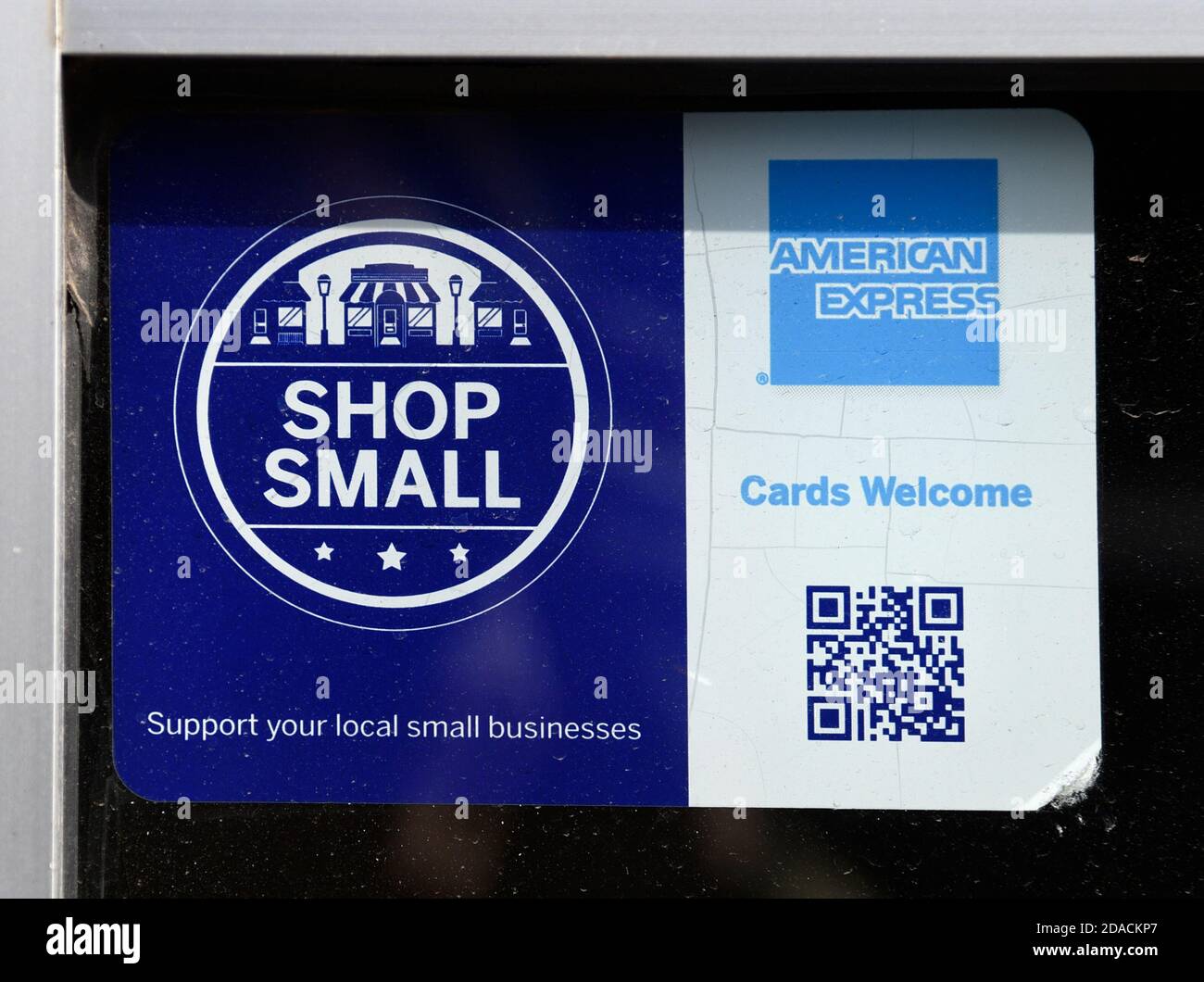 A decal on a window of a shop participating in the American Express