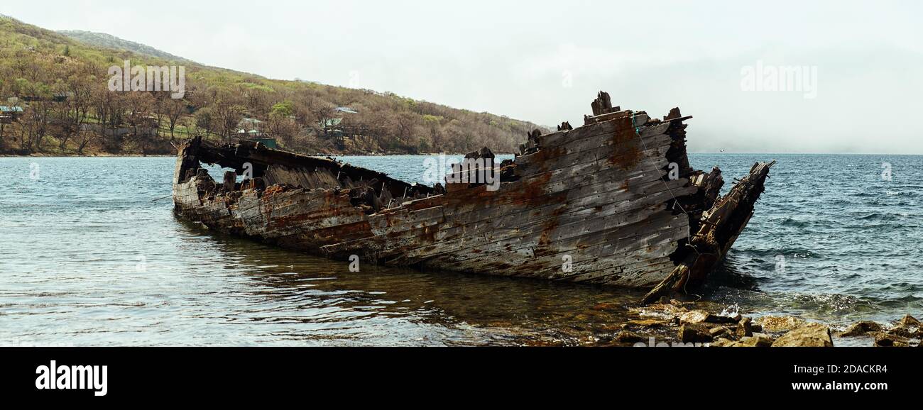 Abandoned wooden ship by the beach Stock Photo - Alamy