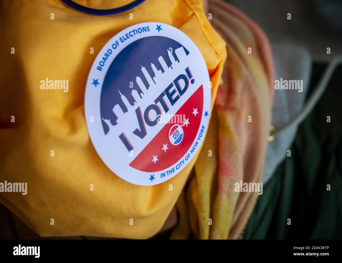 A voter wears her 'I Voted' sticker on her mask on Election Day in New York on Tuesday, November 3, 2020. (© Richard B. Levine) Stock Photo