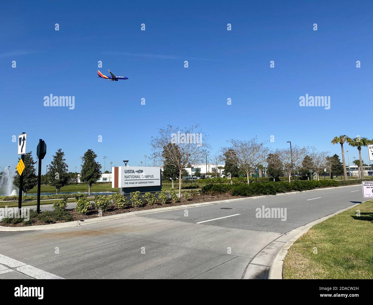 Orlando,FL/USA - 2/29/20:  The sign to the entrance of the United States Tennis Association facilities with a Southwest Airlines plane flying overhead Stock Photo