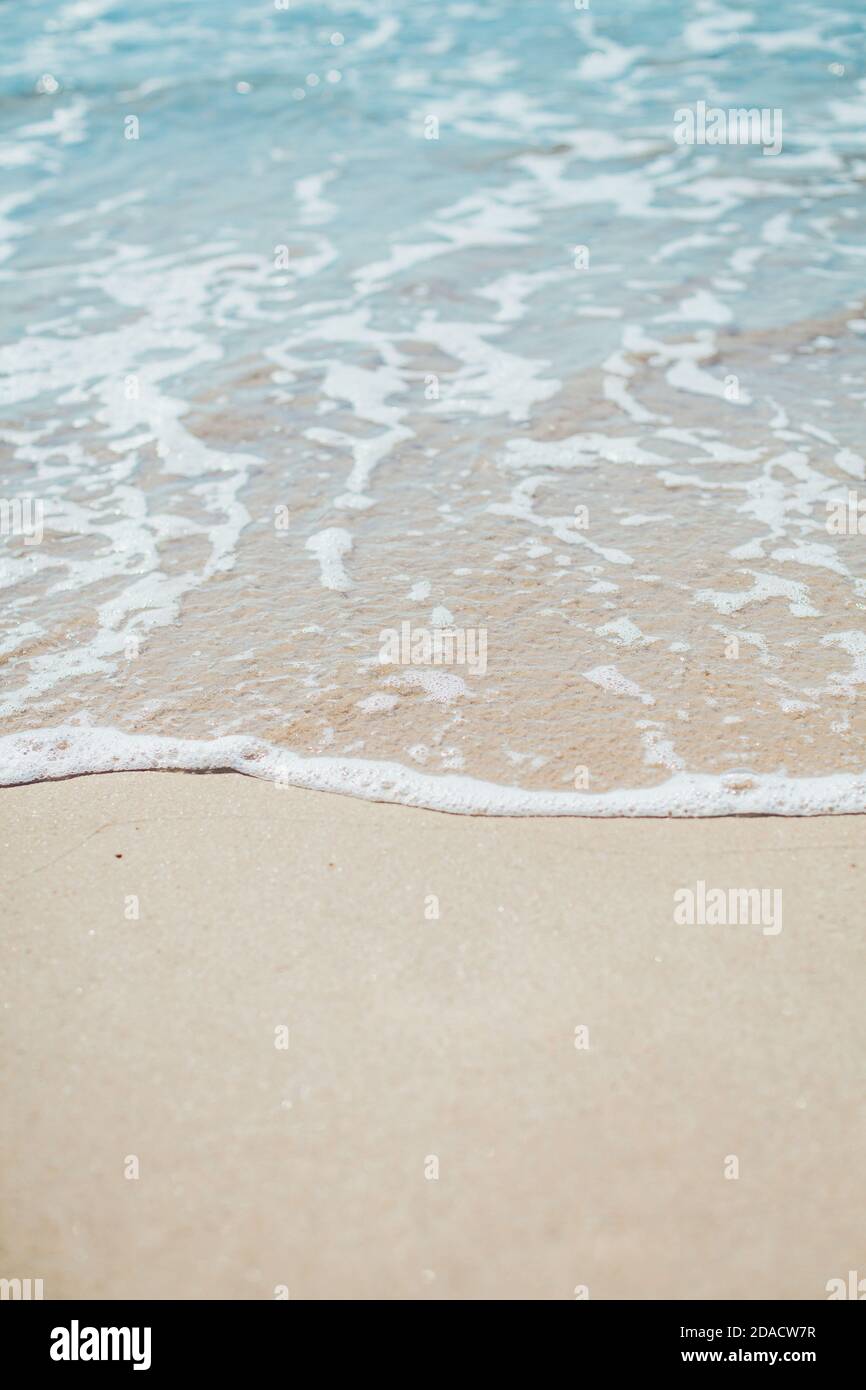 Soft blue ocean wave on sandy beach. Background. Stock Photo