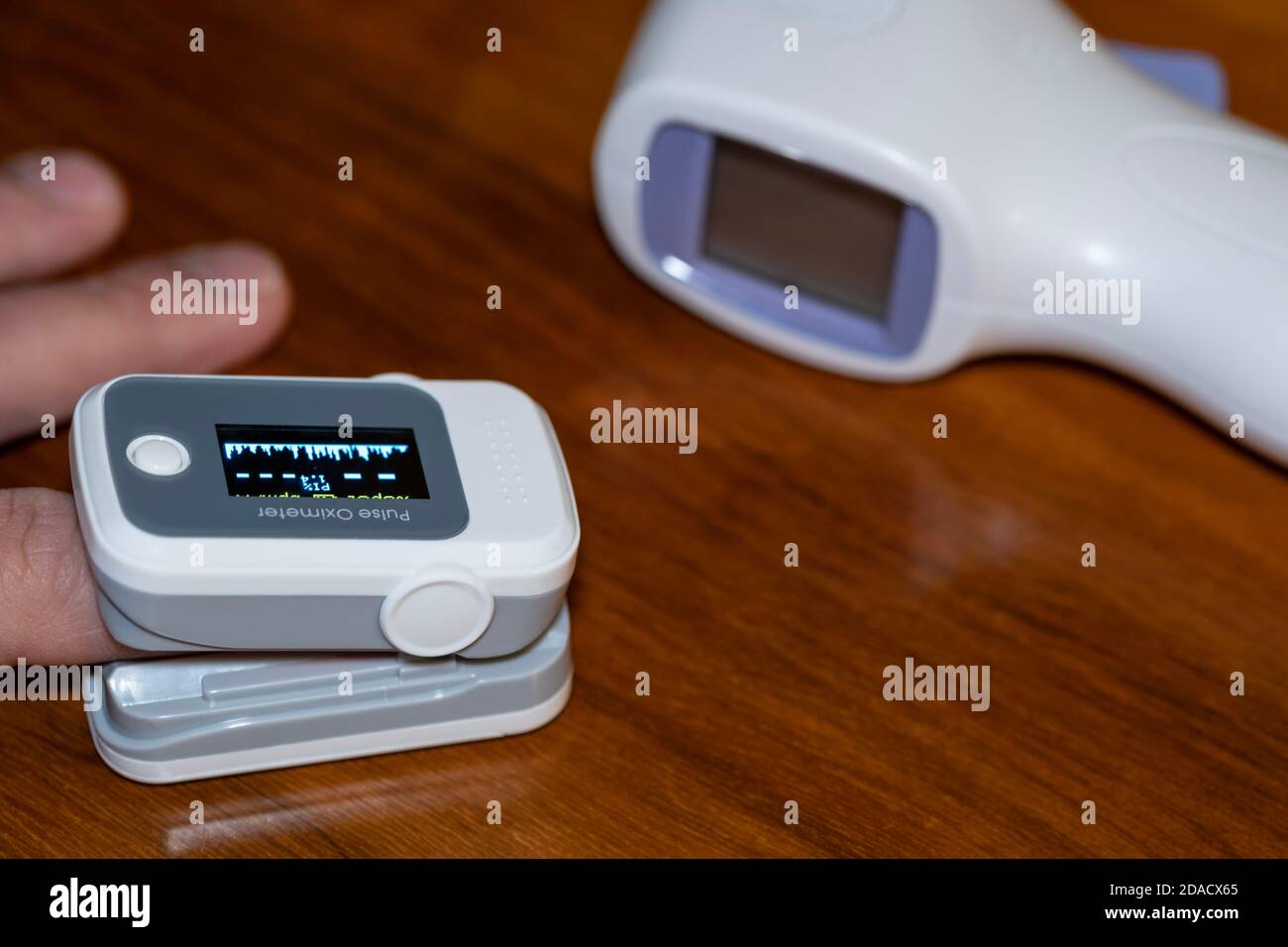 Man using pulse oximeter to measure oxygen saturation in covid19 pandemic disease,medical home monitoring treatment Stock Photo