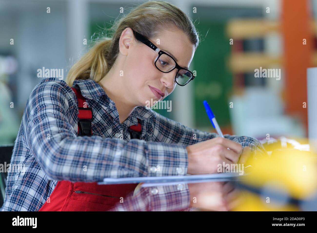 a female worker writing something Stock Photo