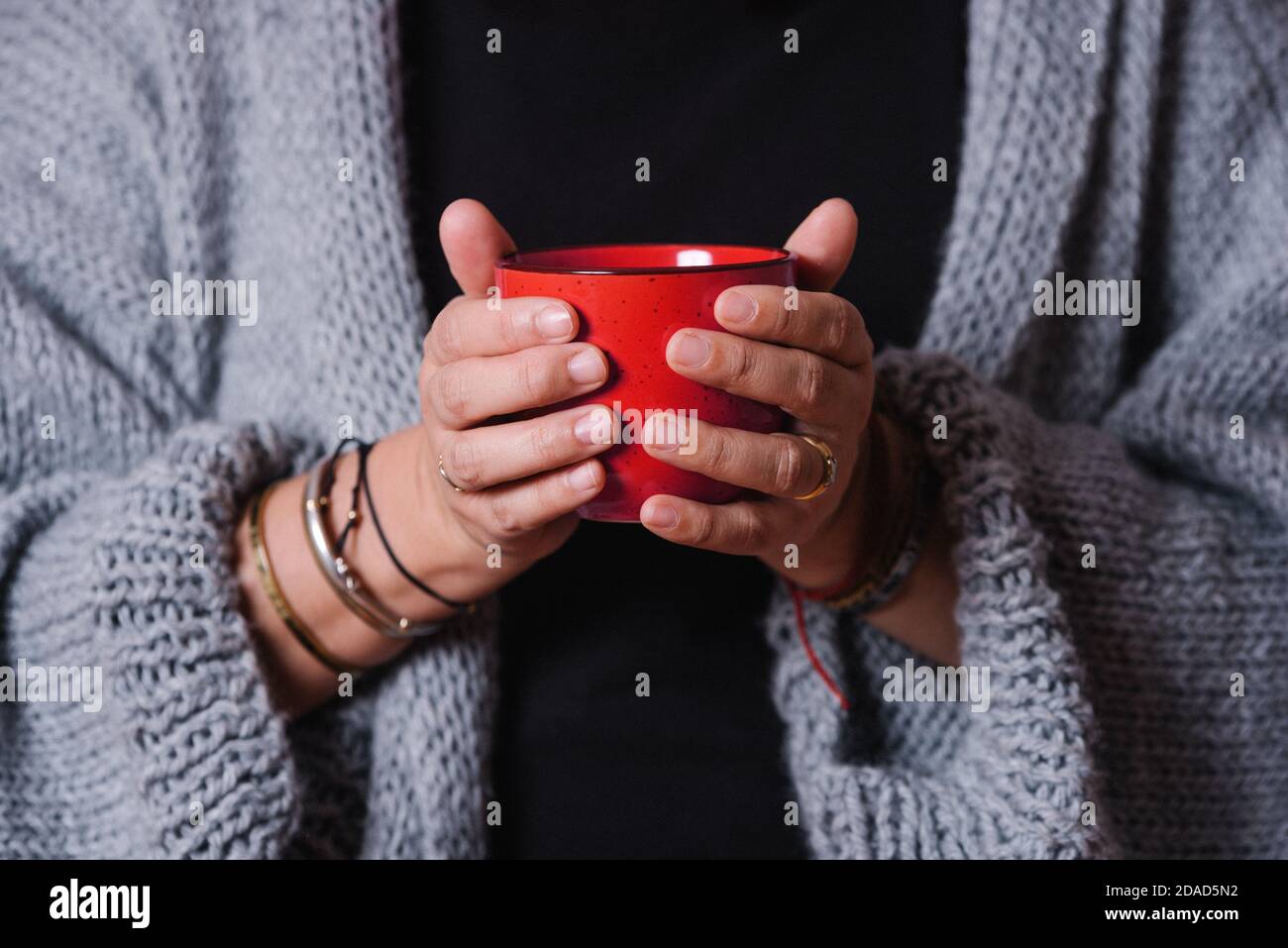 https://c8.alamy.com/comp/2DAD5N2/closeup-of-a-womans-hands-with-a-red-mug-woman-warming-her-hands-with-a-cup-of-coffee-2DAD5N2.jpg