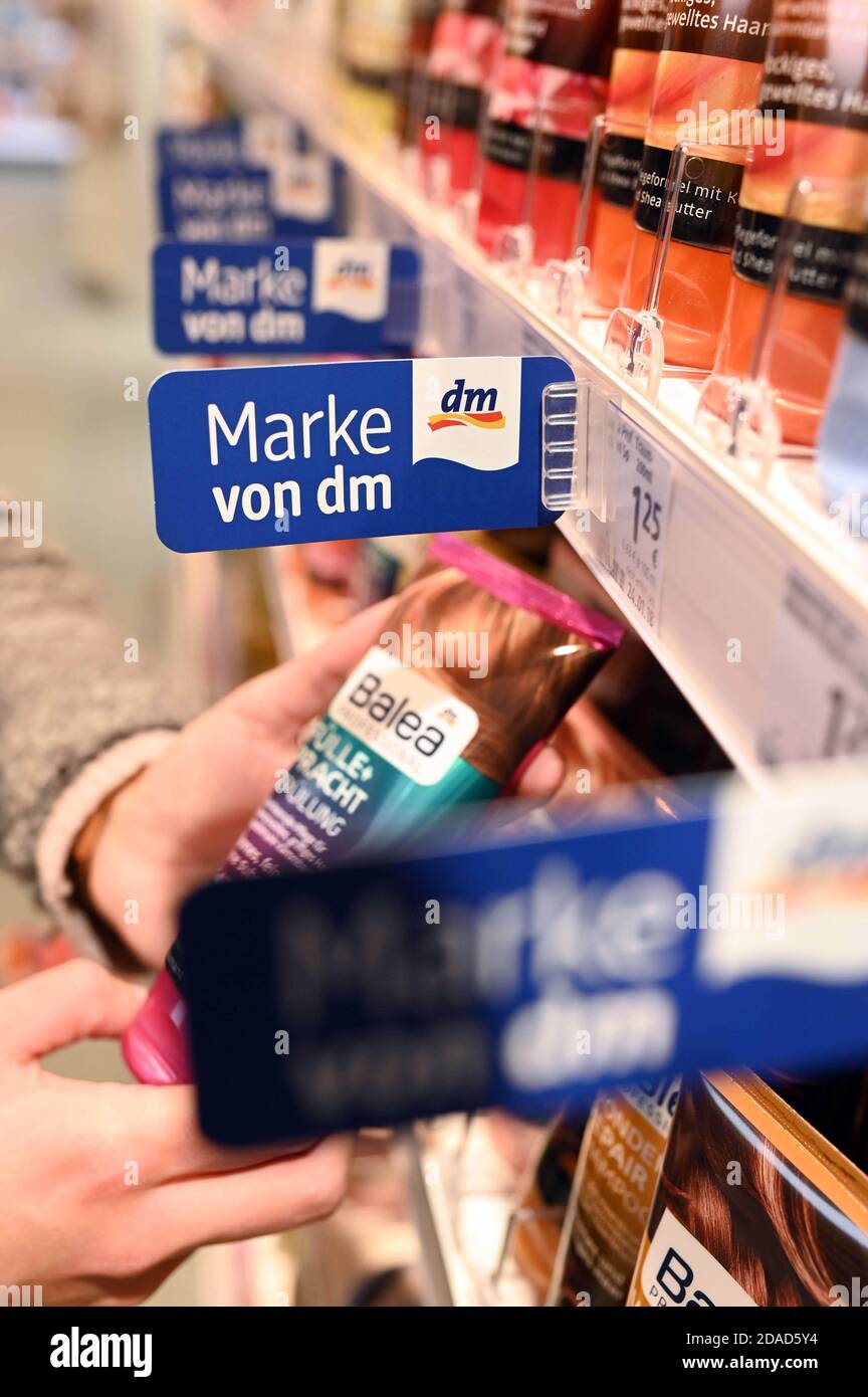 Karlsruhe, Germany. 10th Nov, 2020. A person in a branch of the dm  drugstore chain takes a product of the dm private label Balea from a shelf.  Credit: Uli Deck/dpa/Alamy Live News