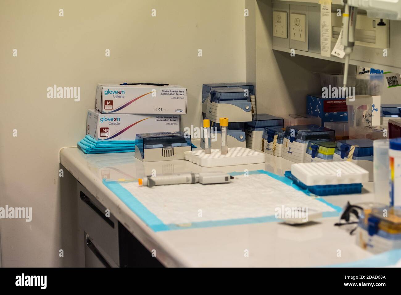 A scientific bench space with tubes pipette tips and other laboratory