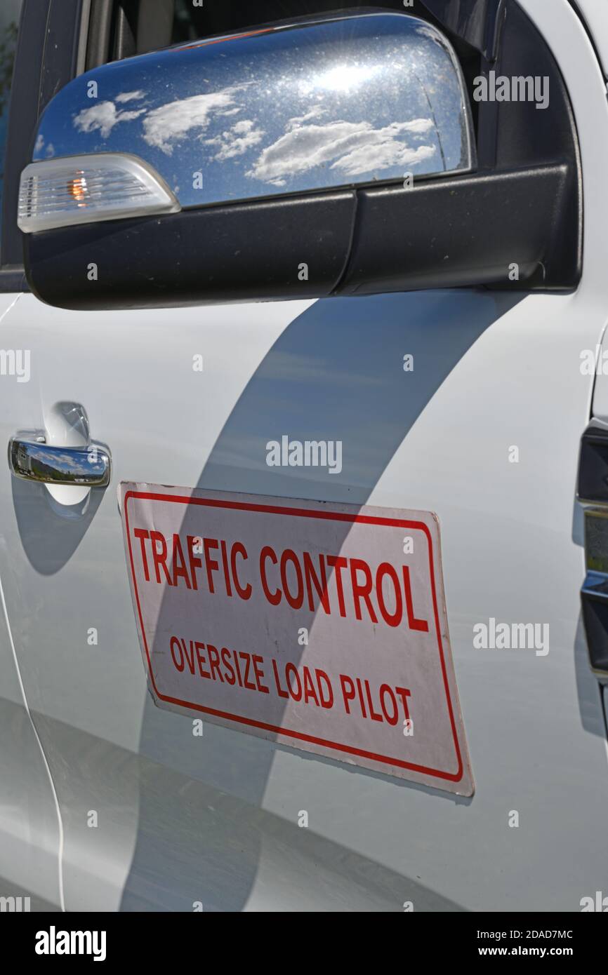 oversize signage displayed on the side of a pilot vehicle for a truck carrying a wide load Stock Photo