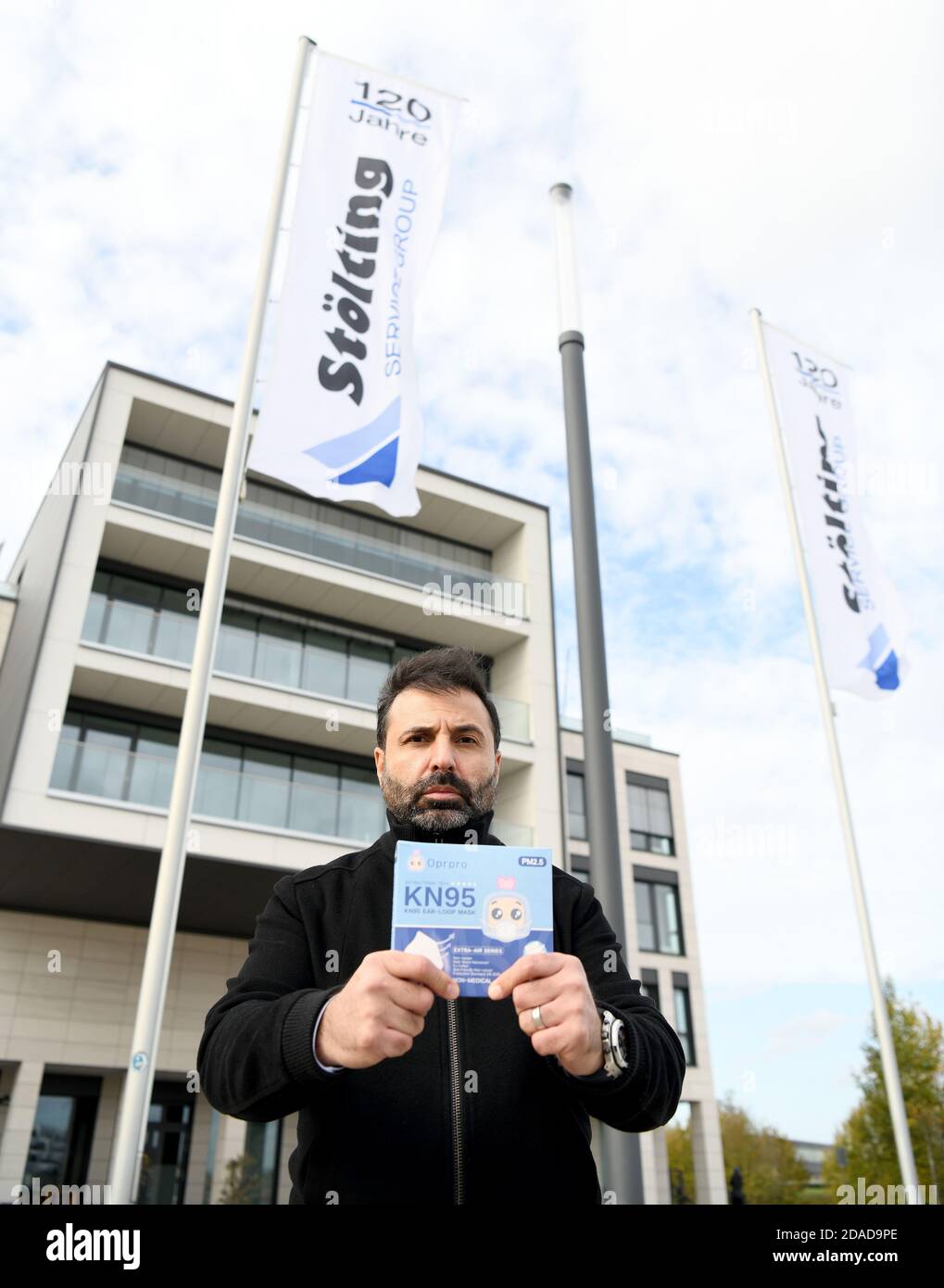 Gelsenkirchen, Germany. 03rd Nov, 2020. Reza Tehrani, manager of the Düsseldorf fashion manufacturer Prps, is standing in front of the Stölting Harbor building, the headquarters of the Stölting Service Group, holding a pack of Oprpro KN95 nose-and-mouth protective masks. (to KORR report: 'The crux with the mouth protection business - company insists on payment') Credit: Caroline Seidel/dpa/Alamy Live News Stock Photo