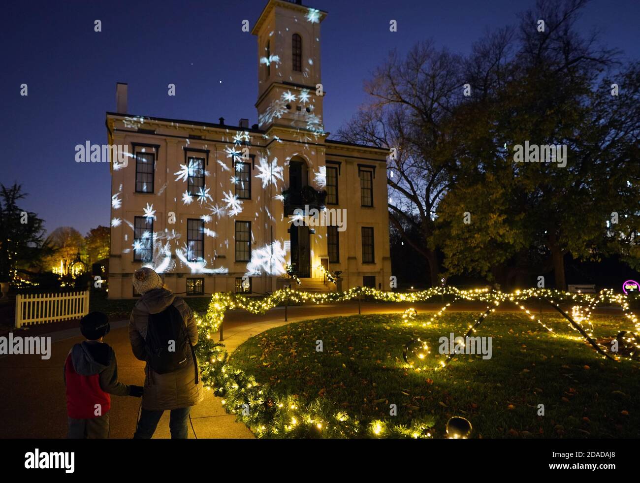St. Louis, United States. 11th Nov, 2020. Visitors to the Henry Shaw home watch amination being projected on the building, on opening night of Garden Glow at The Missouri Botanical Garden in St. Louis on Wednesday, November 11, 2020. Photo by Bill Greenblatt/UPI Credit: UPI/Alamy Live News Stock Photo