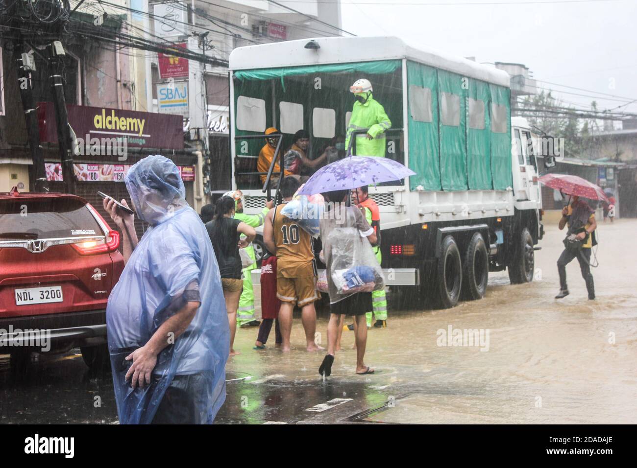 Marikina, Philippines. 12th Nov, 2020.Rescue operation team evacuates individuals and families that are being stranded in their homes. A strong typhoon named 'Ulysses' (Vamco) hits the National Capital Region, Philippines. With its maximum speed of 155 km/h and gustiness of 255 km/h causing flash floods and massive infrastructure damage. Various families have been forced evacuated from their homes. Some have been stranded in their roofs for the past 10 hours waiting for rescue teams. Credit: SOPA Images Limited/Alamy Live News Stock Photo