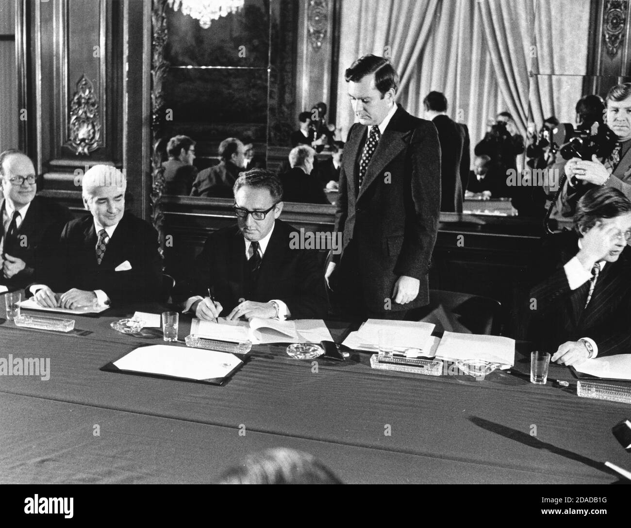 In this photo released by the White House, Assistant to the President (Nixon) for National Security Affairs Henry A. Kissinger, center, initials the Vietnam Peace Agreement in the International Conference Center in Paris, France on Tuesday, January 23, 1973.Mandatory Credit: Robert L. Knudsen/White House via CNP | usage worldwide Stock Photo