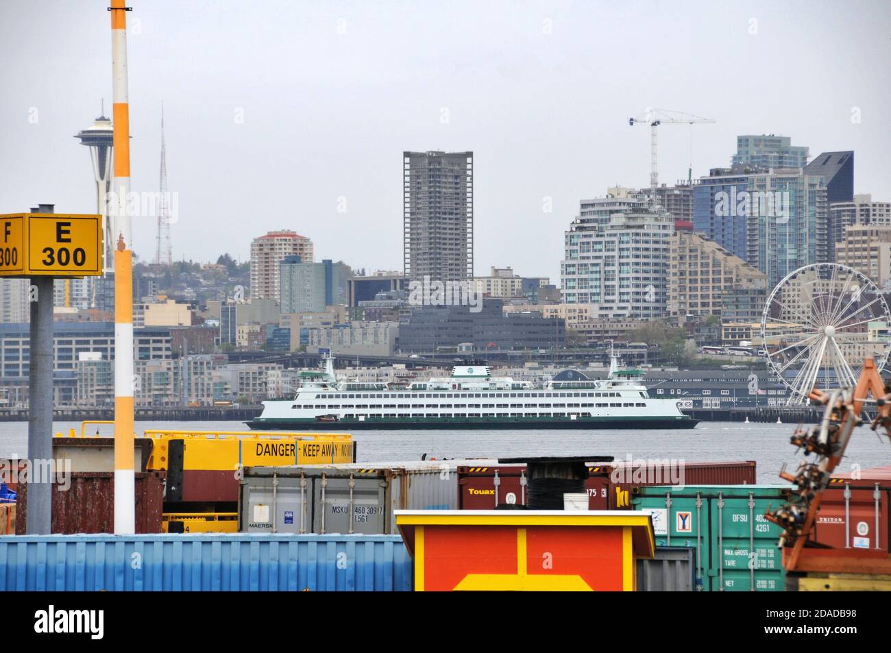 View of shipping dock and Seattle cityscape in the background including Space Needle, Ferris wheel and WA ferry, WA, USA. Stock Photo