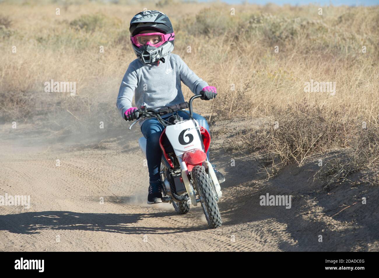 Pre-teen riding mini-dirt bike on a dirt track in Ada County, Idaho, USA Stock Photo