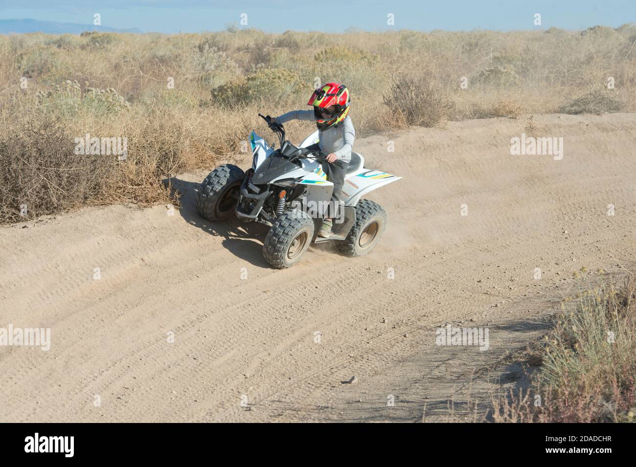 Pre-teen riding mini-Atv on a dirt track in Ada County, Idaho, USA Stock Photo