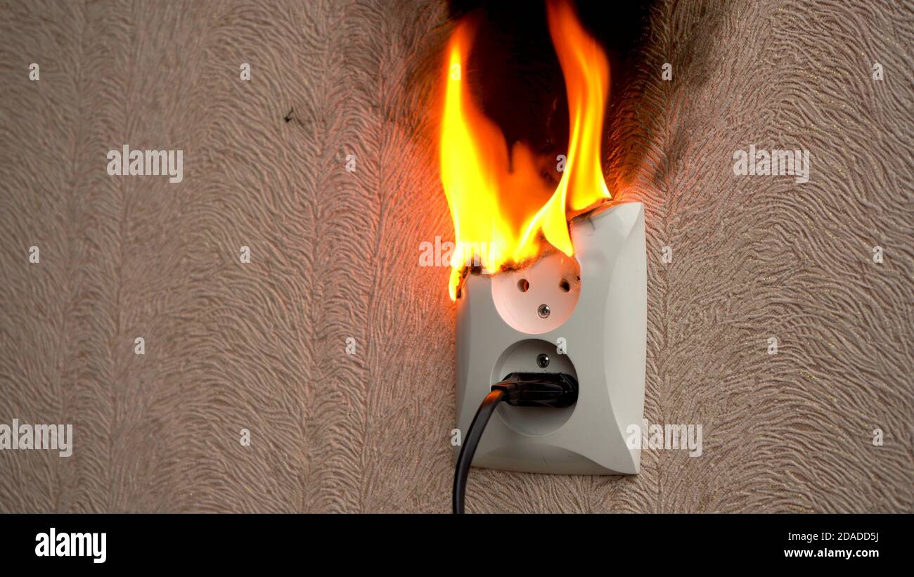 Fire caused by short circuit. The concept of a fire in the house Stock Photo