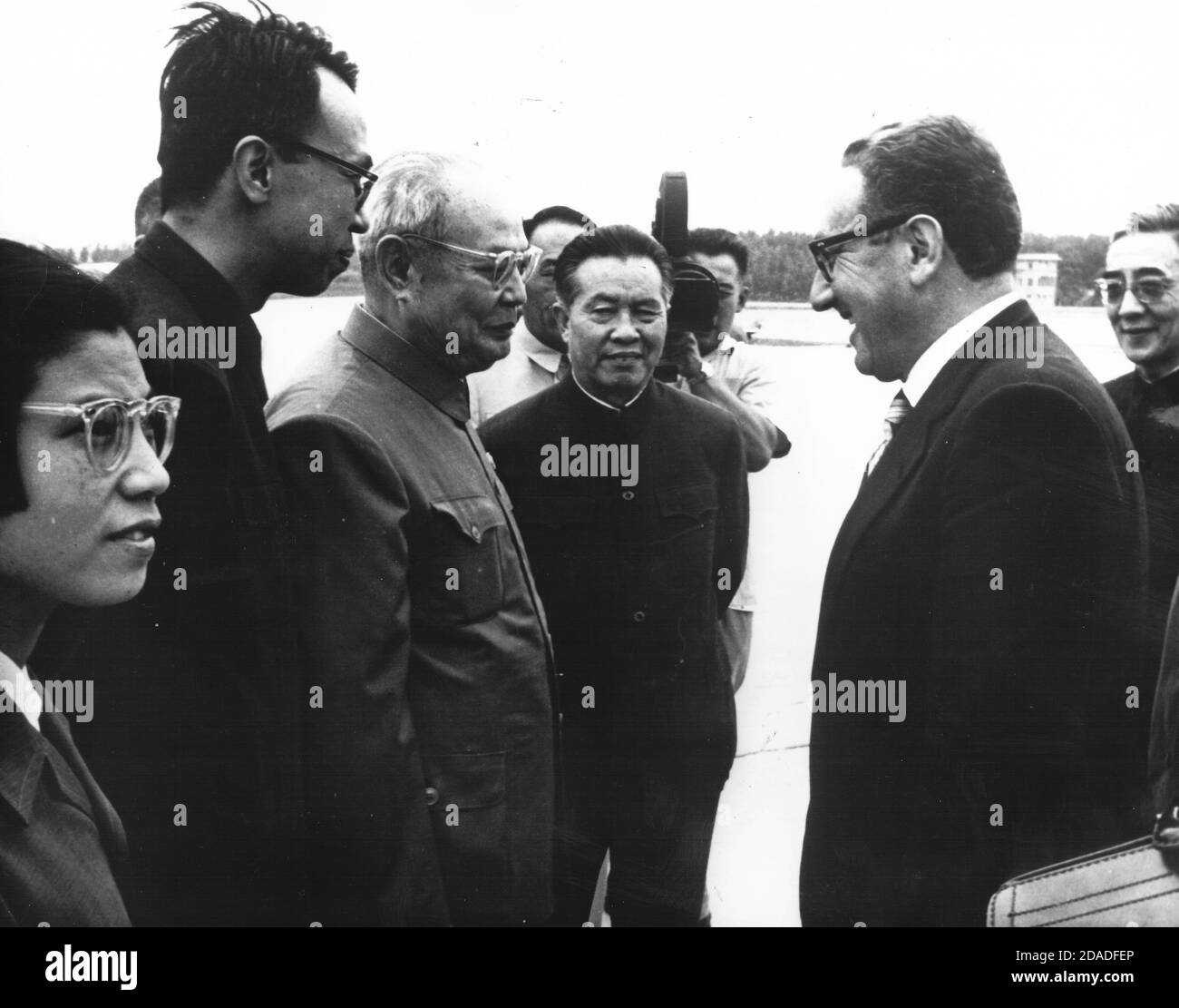 In this photo released by the White House, Dr. Henry A. Kissinger, Assistant to the President (Nixon) for National Security Affairs, second right, is greeted on his arrival in Beijing, China on July 9, 1971.  Welcoming Kissinger, from left to right: unidentified Deputy Chief-of-Protocol; unidentified interpreter; Yeh Chien-ying, Vice Chairman, Military Affairs Commission, Chinese Communist Party; Huang Hua, Ambassador of China to Canada; and at far right, behind Dr. Kissinger, Chang Wen-chin, Director, Western Europe and American Department, Chinese Ministry of Foreign Affairs.  Dr. Kissinger Stock Photo