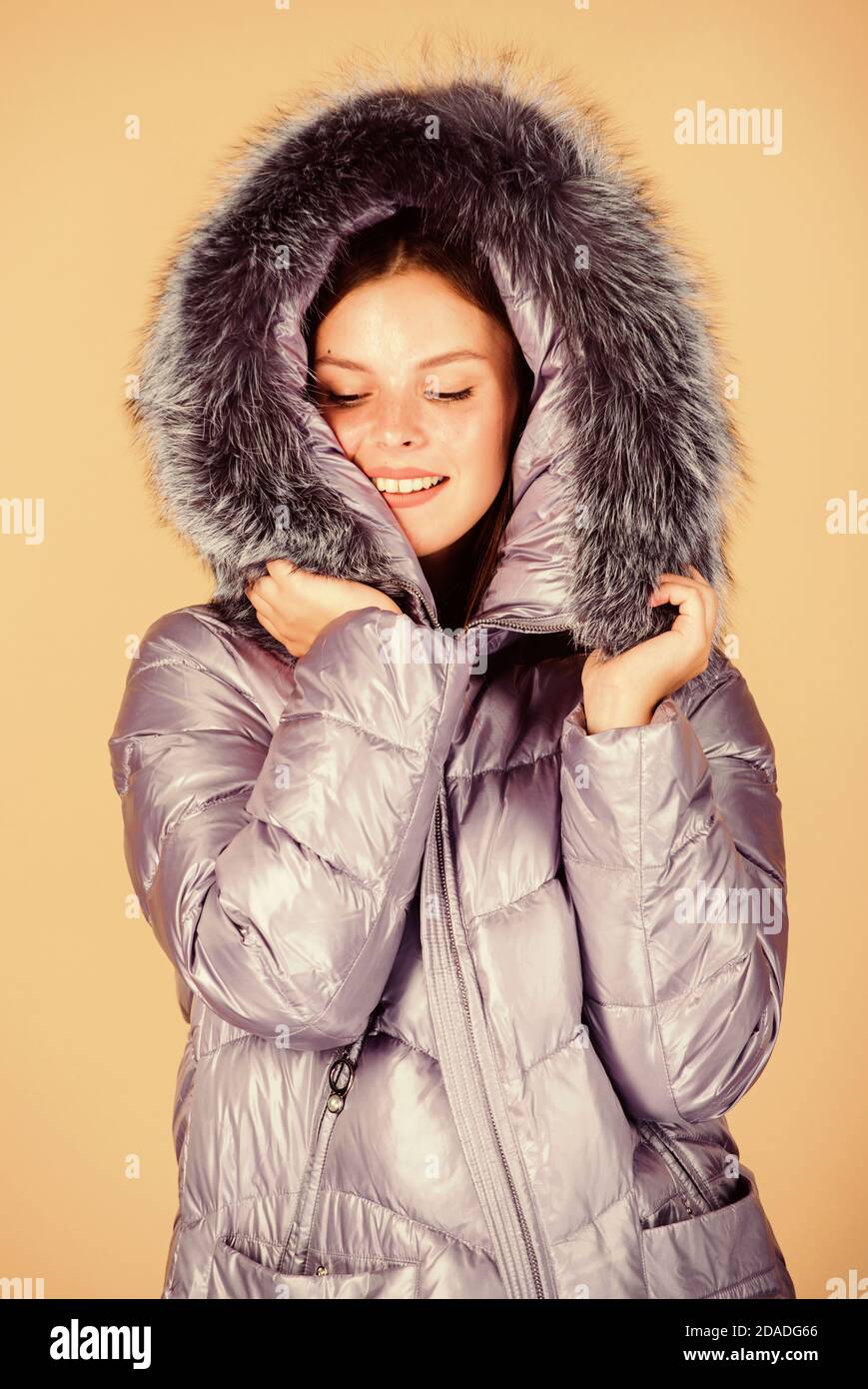 Faux fur. Fashion girl winter clothes. Fashion trend. Fashion coat and hat.  Warming up. Casual winter jacket slightly more stylish and have more  comfort features such as larger hood fur trim on