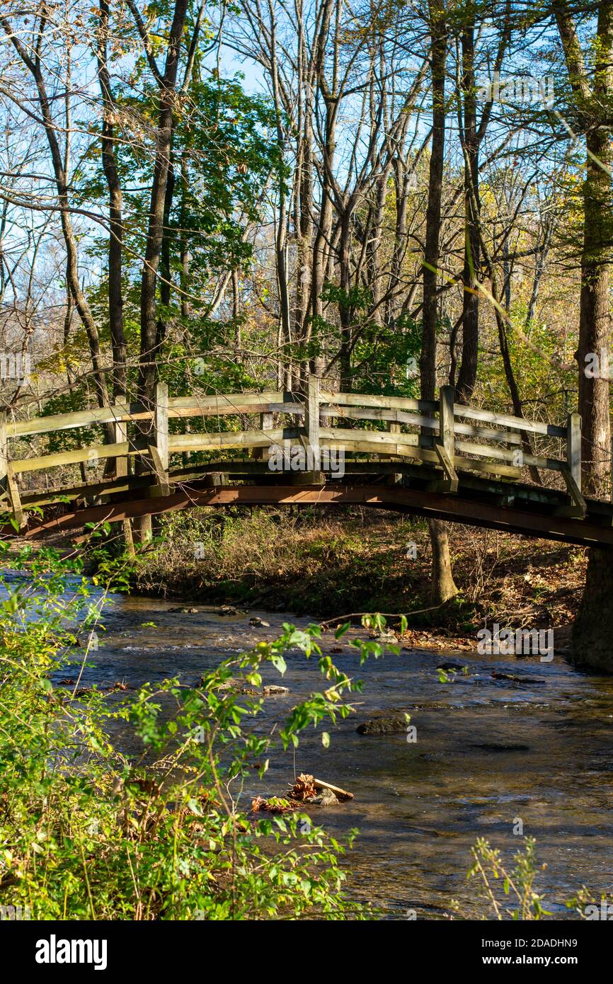 A Wooden Bridge Going Over a Small Stream on a Clear Autumn Day at Valley Forge National Historical Park Stock Photo
