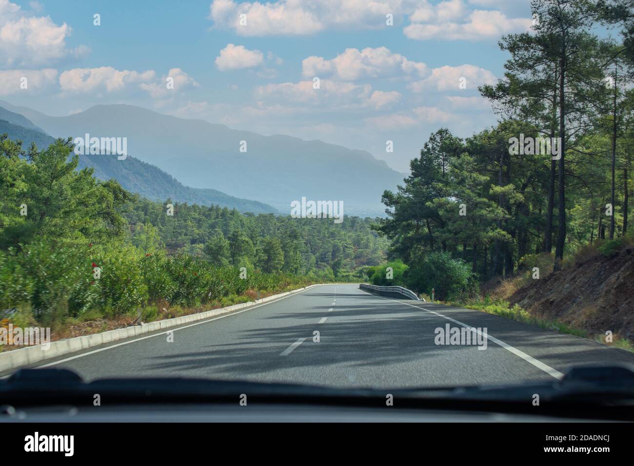 View from the windshield of a car driving along a sunset road. Road ...