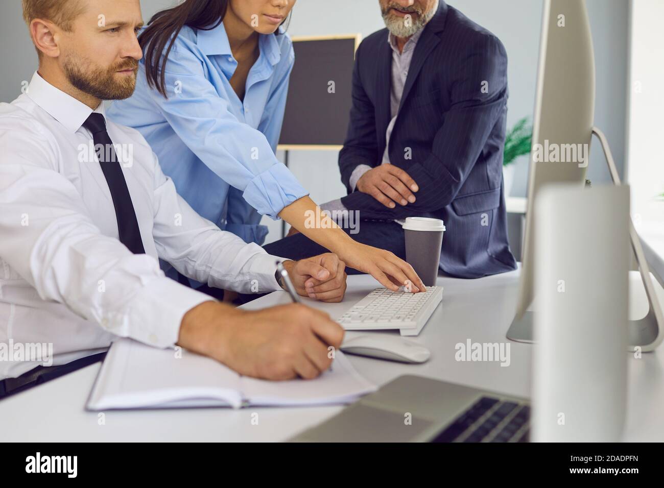 Diverse business people working on important project and using computer for marketing research Stock Photo