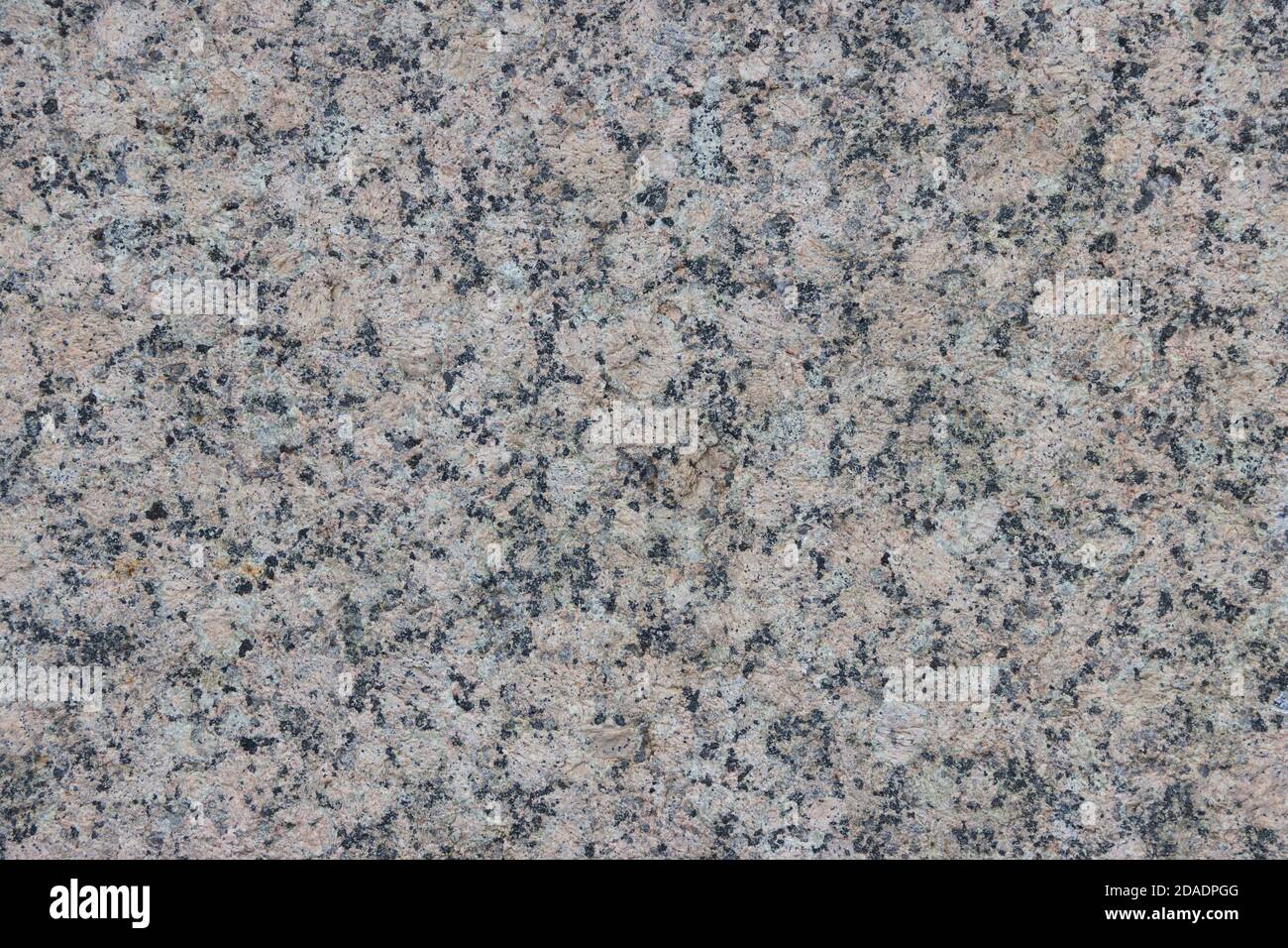 The texture of a variegated speckled polished marble slab. Stock Photo