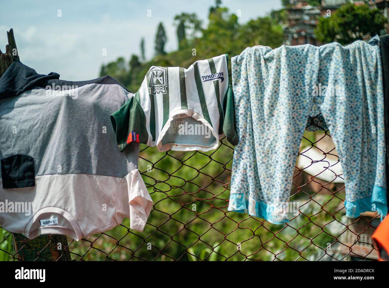 ITAGUI, COLOMBIA - Mar 16, 2019: Itagui, Antioquia / Colombia - March 15 2019: Children's Clothes Hanging and Drying of the Sun over in a Fence Stock Photo