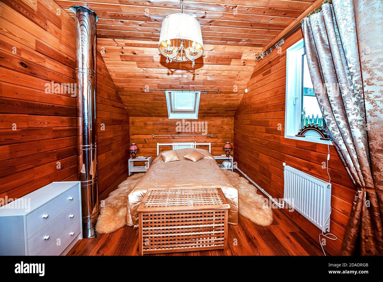 Interior of the bedroom in a wooden village house is made of birch timber-clapboard. Stock Photo
