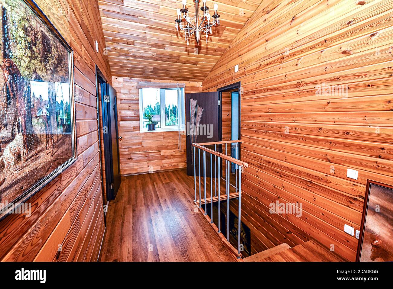 Interior of the bedroom in a wooden village house is made of birch timber-clapboard. Stock Photo