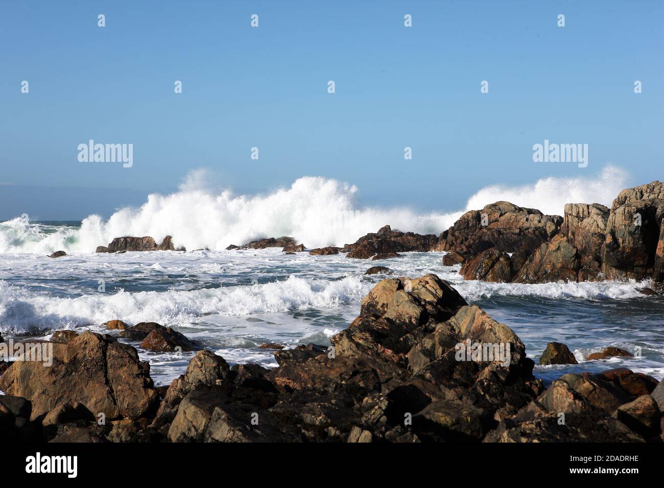 Waves crashing on to the rocky coastline of the Isle of Iona in the Inner Hebrides of Scotland Stock Photo