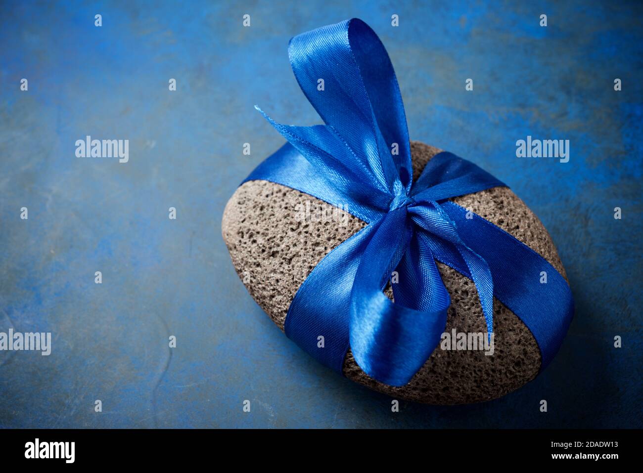 Stone with a blue bow. Stock Photo