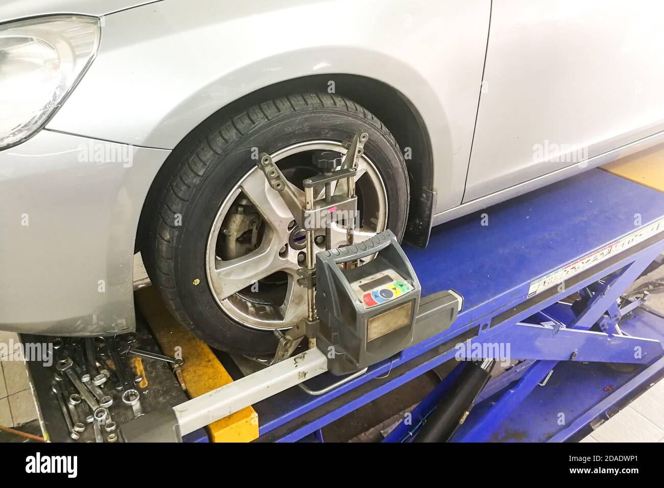 Car undergo wheel align in garage Stock Photo - Alamy