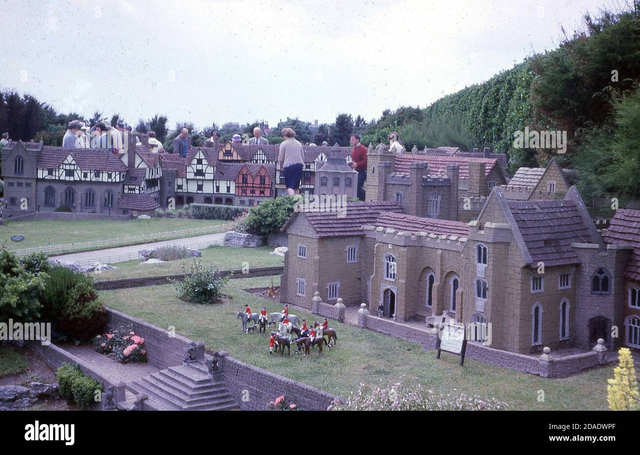 1960s, historical photo Model Village in White Rock Gardens, Hastings, E. Sussex, England, UK and a view of Callis Court Manor in miniature scale.  Designed by Stanley Deboo and opened in 1955, the village was constructed by Benjamin White, following the successful one he had bult in Ramsgate. The model village in Hastings was named 'Ganymeade' and featured small scale reproductions of many famous Sussex buildings. Although popular, it was removed in 1998 due to vandalism issues. Stock Photo